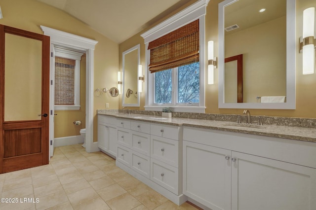 bathroom featuring vaulted ceiling, vanity, and toilet