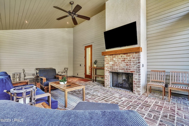 view of patio with an outdoor living space with a fireplace and ceiling fan