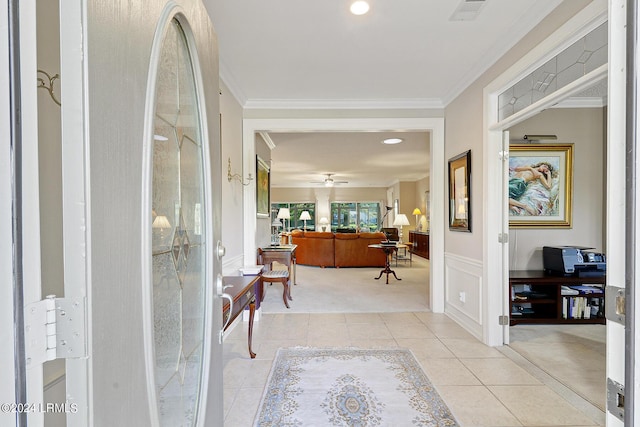 hall with light tile patterned floors and crown molding