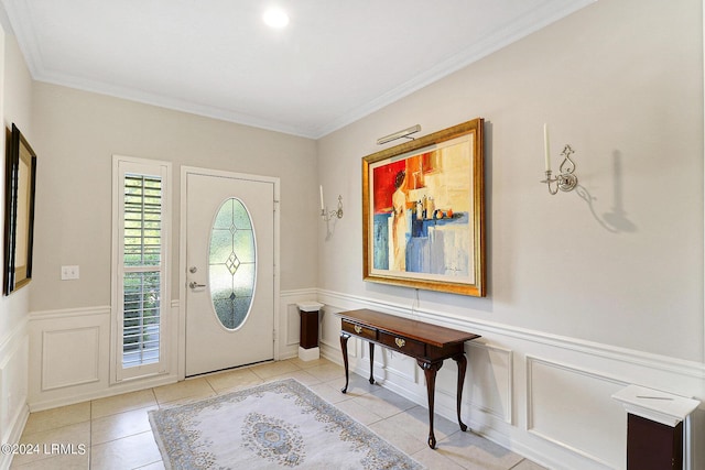 tiled entryway featuring crown molding