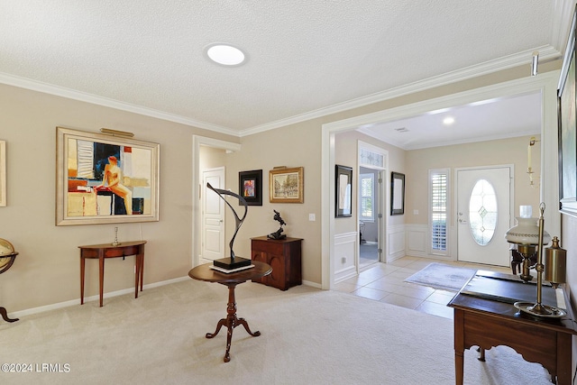 entrance foyer featuring crown molding, light carpet, and a textured ceiling