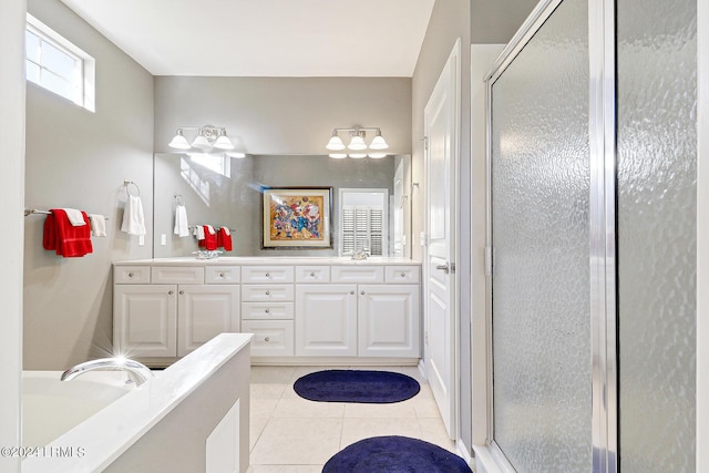 bathroom featuring tile patterned floors, vanity, and a shower with shower door