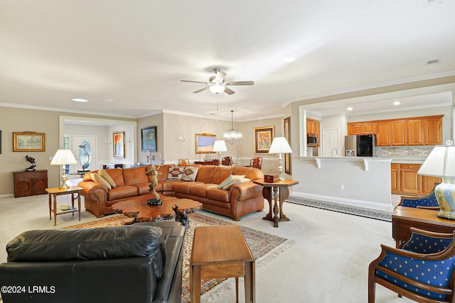 living room with crown molding, ceiling fan with notable chandelier, light colored carpet, and a textured ceiling