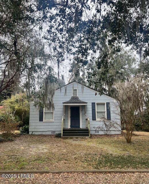 bungalow with a shingled roof, a front yard, and crawl space