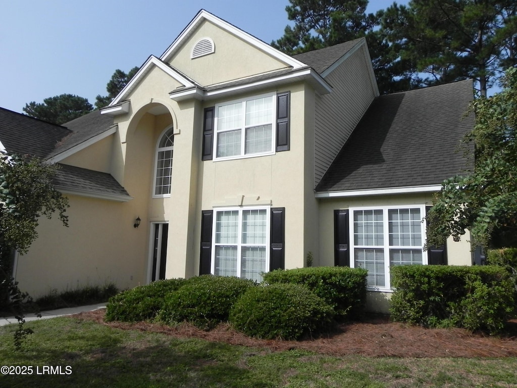 130 Pinecrest Dr, Bluffton, SC 29910 - traditional-style house with a shingled roof and stucco siding
