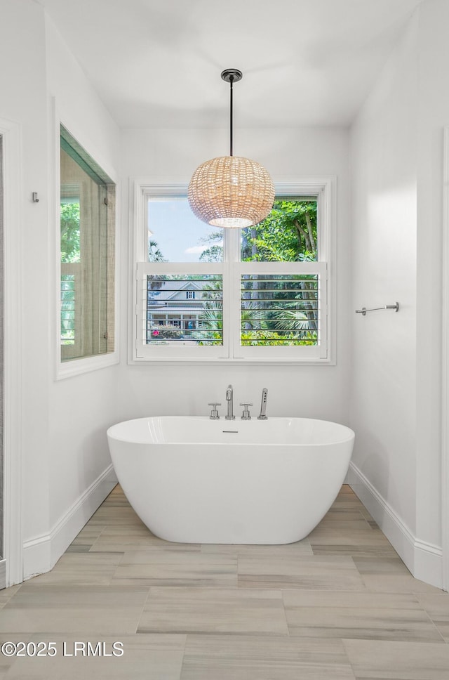 1 Wild Magnolia Ct, Okatie, SC 29909 - bathroom with a soaking tub, baseboards, and a chandelier