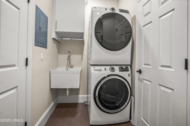 1 Wild Magnolia Ct, Okatie, SC 29909 - clothes washing area with estacked washer and dryer, electric panel, baseboards, cabinet space, and dark tile patterned flooring