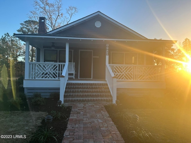 view of front of property featuring a porch and a chimney