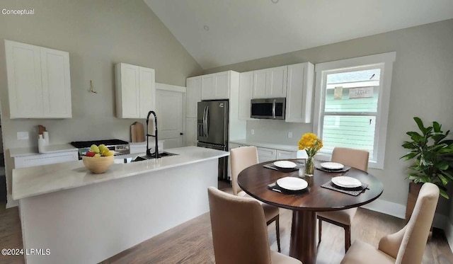 kitchen featuring sink, black refrigerator with ice dispenser, a center island with sink, light hardwood / wood-style floors, and white cabinets