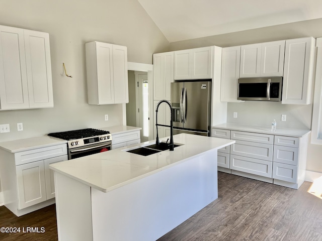 kitchen with a kitchen island with sink, sink, white cabinets, and appliances with stainless steel finishes