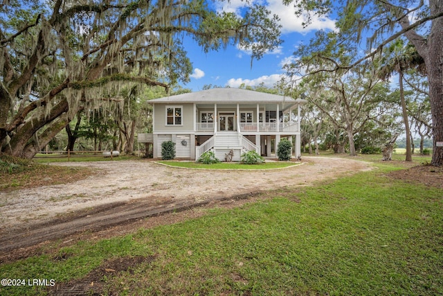 view of front of property with covered porch and a front lawn