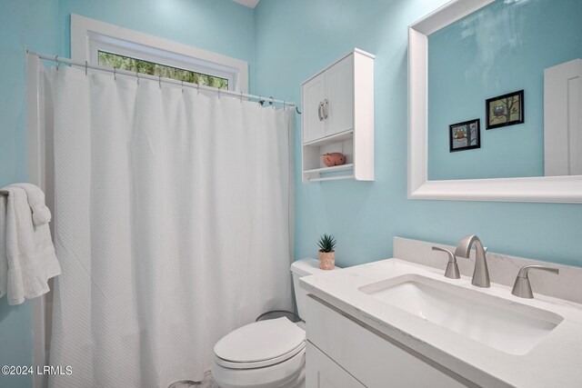 bathroom featuring vanity and toilet