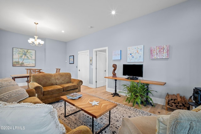 living room with hardwood / wood-style floors and a notable chandelier