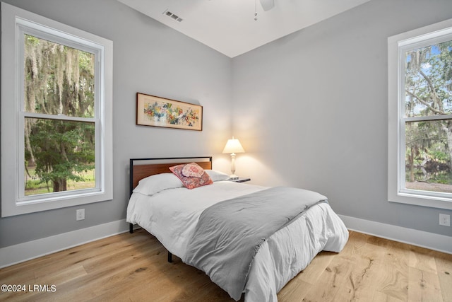 bedroom with ceiling fan and light hardwood / wood-style flooring