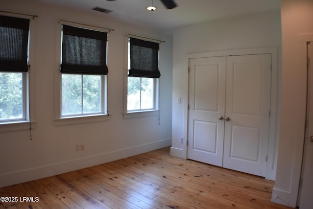 unfurnished bedroom with a closet and light hardwood / wood-style flooring