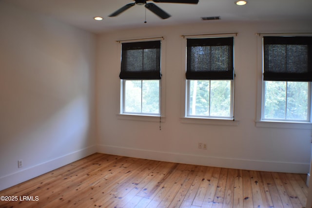 empty room featuring ceiling fan and light hardwood / wood-style flooring