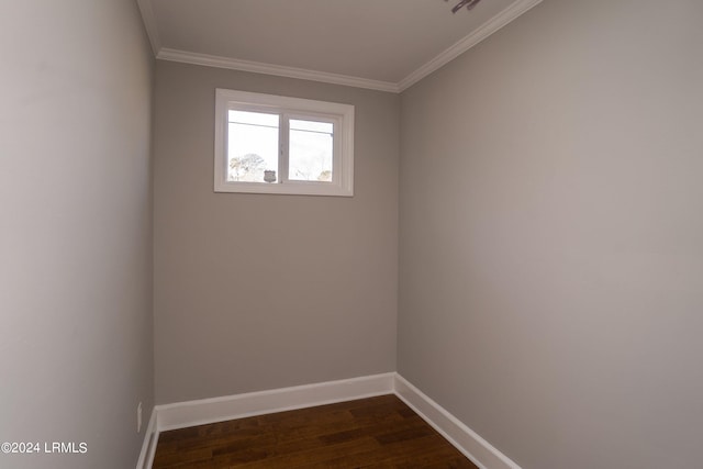 empty room featuring ornamental molding and dark hardwood / wood-style floors