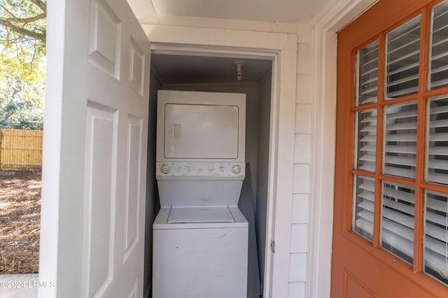 clothes washing area featuring stacked washer / dryer