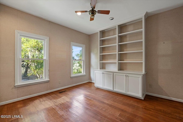 10 Broomfield Ln, Beaufort, SC 29907 - spare room featuring wood finished floors, plenty of natural light, and baseboards
