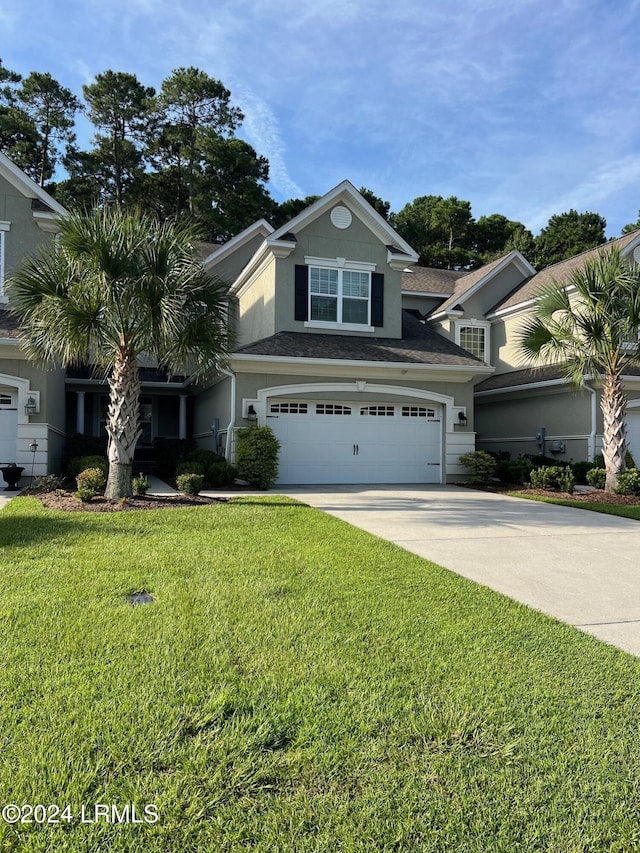 view of front of home with a garage and a front lawn