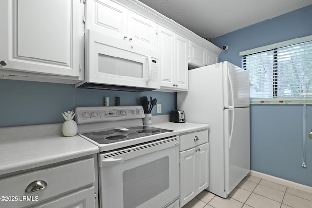 96 Mathews Dr Unit 145, Hilton Head Island, SC 29926 - kitchen with white appliances, white cabinets, light countertops, and light tile patterned flooring