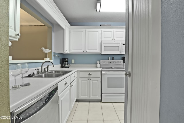 96 Mathews Dr Unit 145, Hilton Head Island, SC 29926 - kitchen featuring white appliances, light tile patterned floors, light countertops, and white cabinetry