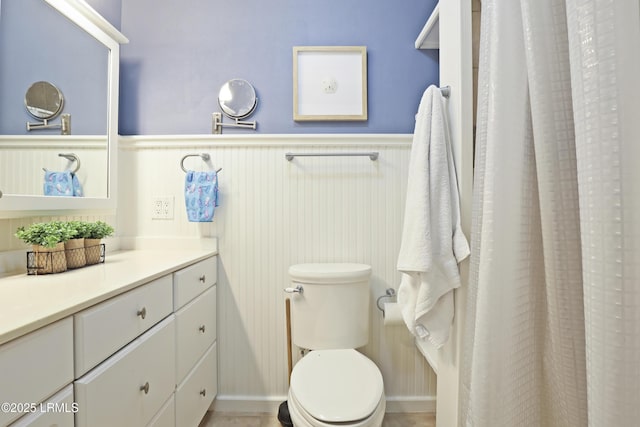 96 Mathews Dr Unit 145, Hilton Head Island, SC 29926 - bathroom featuring a wainscoted wall, vanity, and a shower with curtain