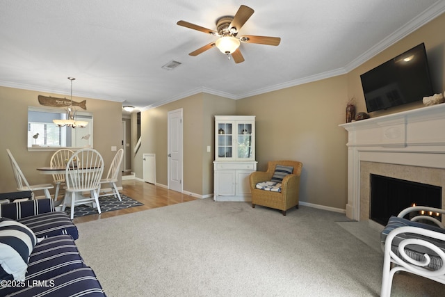 96 Mathews Dr Unit 145, Hilton Head Island, SC 29926 - living area featuring ceiling fan, ornamental molding, a chandelier, a fireplace with flush hearth, and carpet flooring