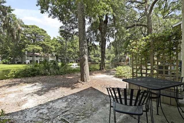 96 Mathews Dr Unit 145, Hilton Head Island, SC 29926 - view of patio / terrace with a water view and view of wooded area
