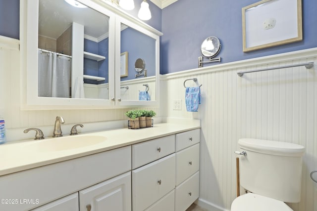 96 Mathews Dr Unit 145, Hilton Head Island, SC 29926 - bathroom with vanity, a decorative wall, wainscoting, curtained shower, and ornamental molding