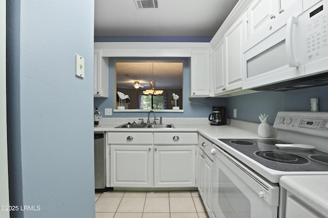 96 Mathews Dr Unit 145, Hilton Head Island, SC 29926 - kitchen featuring white appliances, light countertops, white cabinets, light tile patterned floors, and a chandelier