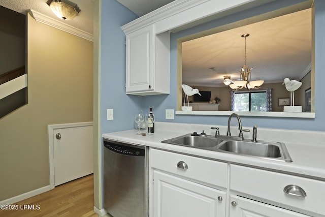 96 Mathews Dr Unit 145, Hilton Head Island, SC 29926 - kitchen with stainless steel dishwasher, a chandelier, light wood-style flooring, light countertops, and ornamental molding