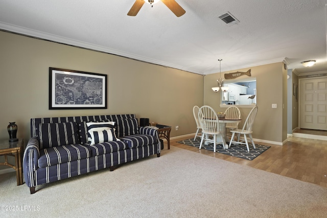 96 Mathews Dr Unit 145, Hilton Head Island, SC 29926 - carpeted living room with ornamental molding, a ceiling fan, and wood finished floors