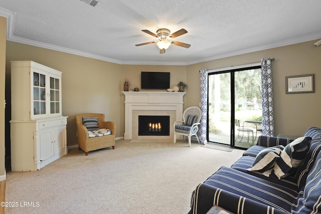 96 Mathews Dr Unit 145, Hilton Head Island, SC 29926 - living area featuring ornamental molding, a warm lit fireplace, ceiling fan, a textured ceiling, and light colored carpet