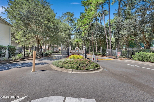 96 Mathews Dr Unit 145, Hilton Head Island, SC 29926 - view of asphalt road featuring a gated entry and curbs