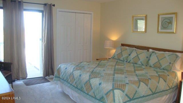 carpeted bedroom featuring a closet