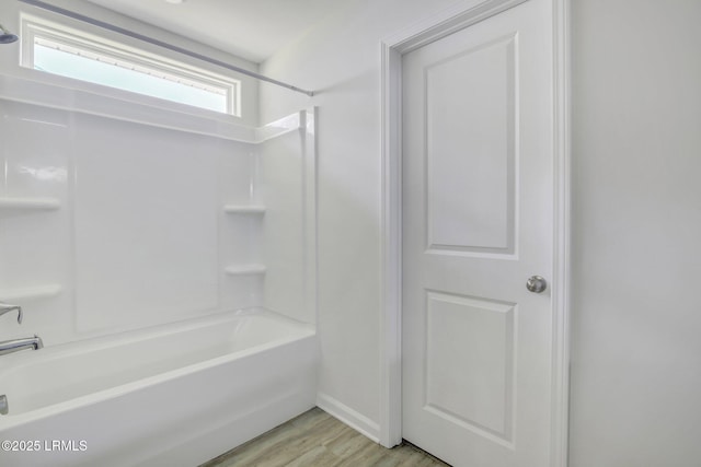 full bath featuring tub / shower combination and wood finished floors