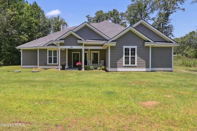 100 Drayton Dr, Ridgeland, SC 29936 - view of front of property featuring a chimney, a shingled roof, and a front yard