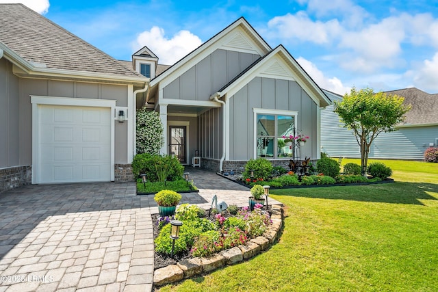 view of front of house featuring a front lawn, board and batten siding, a garage, and decorative driveway