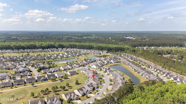 bird's eye view featuring a water view, a view of trees, and a residential view