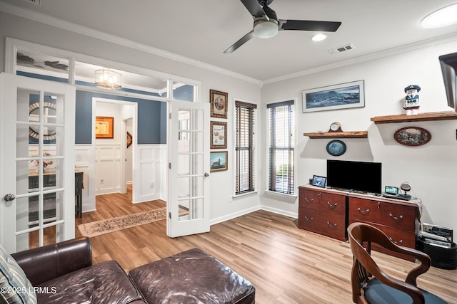 office space with french doors, light wood finished floors, ceiling fan, visible vents, and crown molding