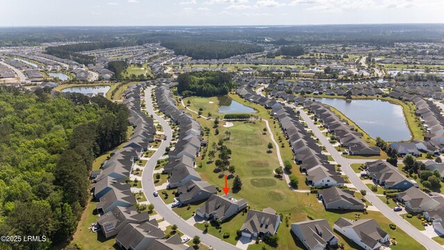drone / aerial view with a water view and a residential view