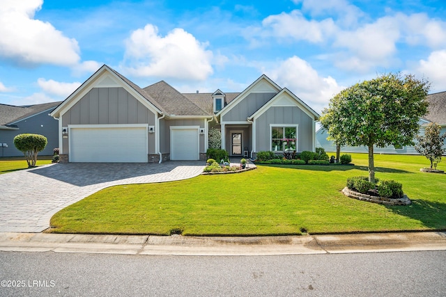 view of front of property with an attached garage, board and batten siding, decorative driveway, and a front yard