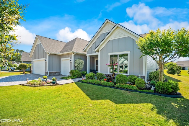 ranch-style house with an attached garage, a front lawn, board and batten siding, decorative driveway, and a shingled roof