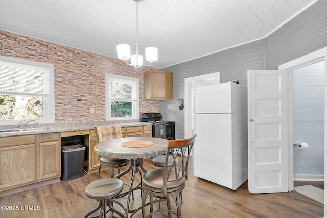 123 Moore St, Walterboro, SC 29488 - kitchen featuring freestanding refrigerator, light brown cabinets, black range with electric cooktop, wood finished floors, and a chandelier