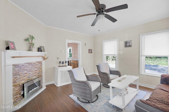 123 Moore St, Walterboro, SC 29488 - living room featuring healthy amount of natural light, dark wood-type flooring, ceiling fan, and a stone fireplace