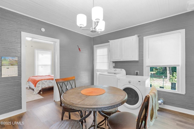 123 Moore St, Walterboro, SC 29488 - dining room with washing machine and clothes dryer, a chandelier, and wood finished floors