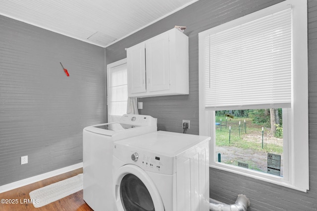 123 Moore St, Walterboro, SC 29488 - washroom featuring cabinet space, separate washer and dryer, and wood finished floors