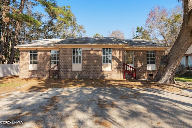 back of house with entry steps, fence, brick siding, and crawl space