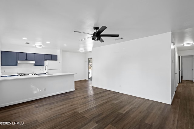 unfurnished living room with visible vents, dark wood-type flooring, and a ceiling fan